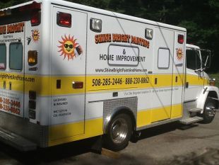 White and yellow Sunny Street Home Improvements truck parked outdoors with company logo and phone number