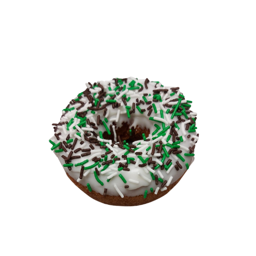 A donut with white frosting and green sprinkles