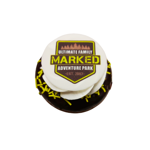 A chocolate donut with the words marked adventure park on it