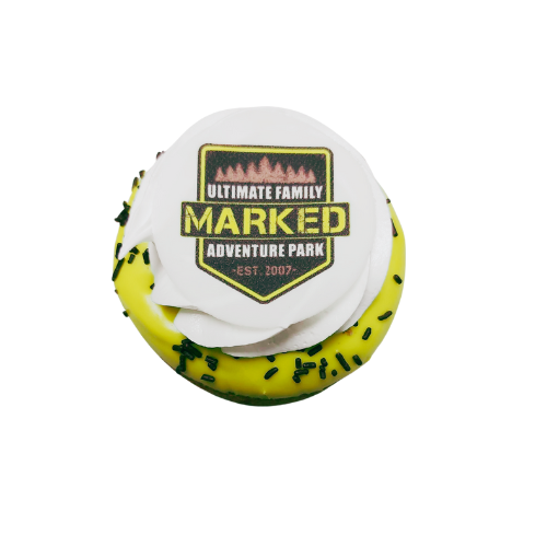 A cupcake with a logo for the ultimate family marked adventure park