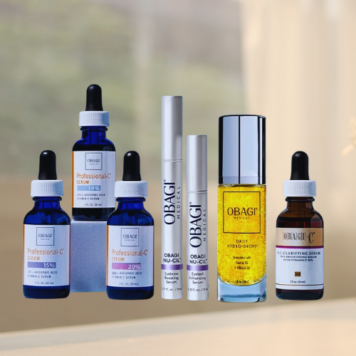 Assorted OBAGI skincare bottles and tubes arranged on a light surface against a soft background