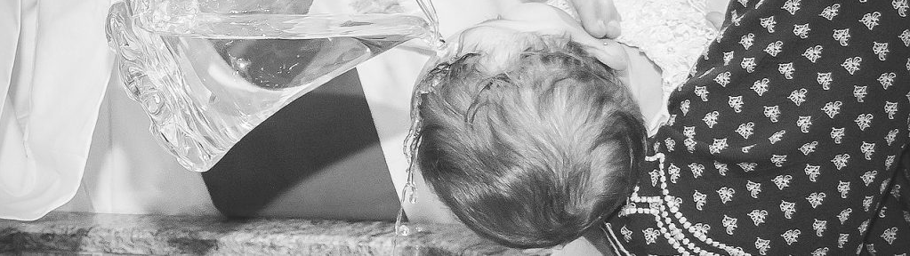 A baby's head, some clothing, and a patterned shirt.