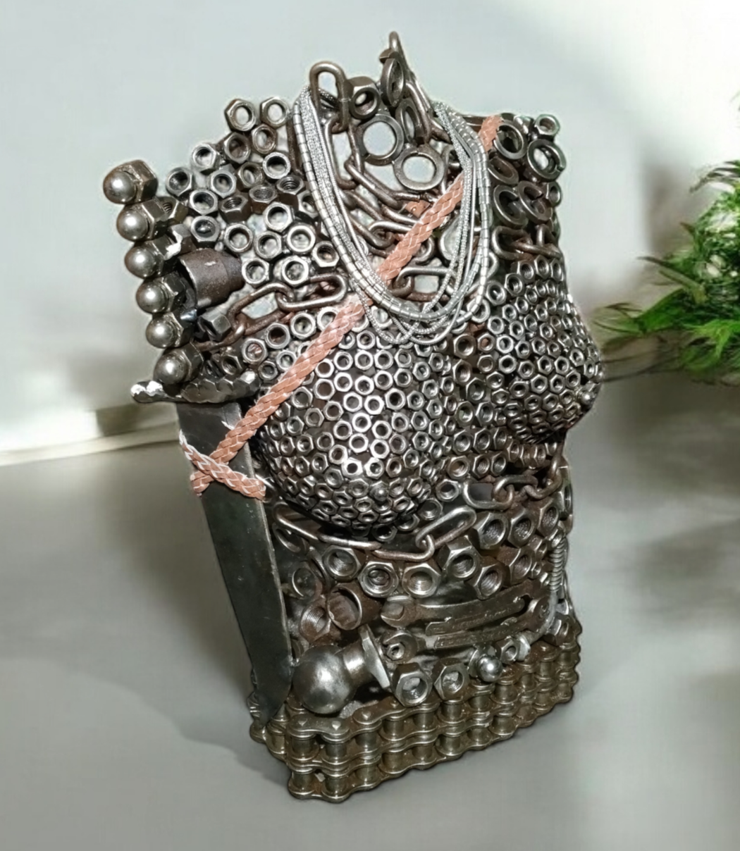 Metal torso sculpture made of hardware parts and chain. Decorated with pink and silver beaded accents.