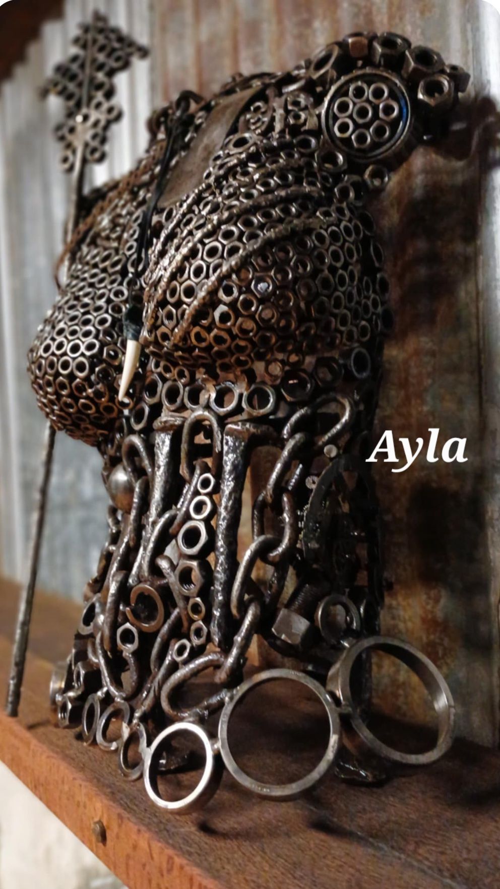 Metal torso sculpture made of hardware.