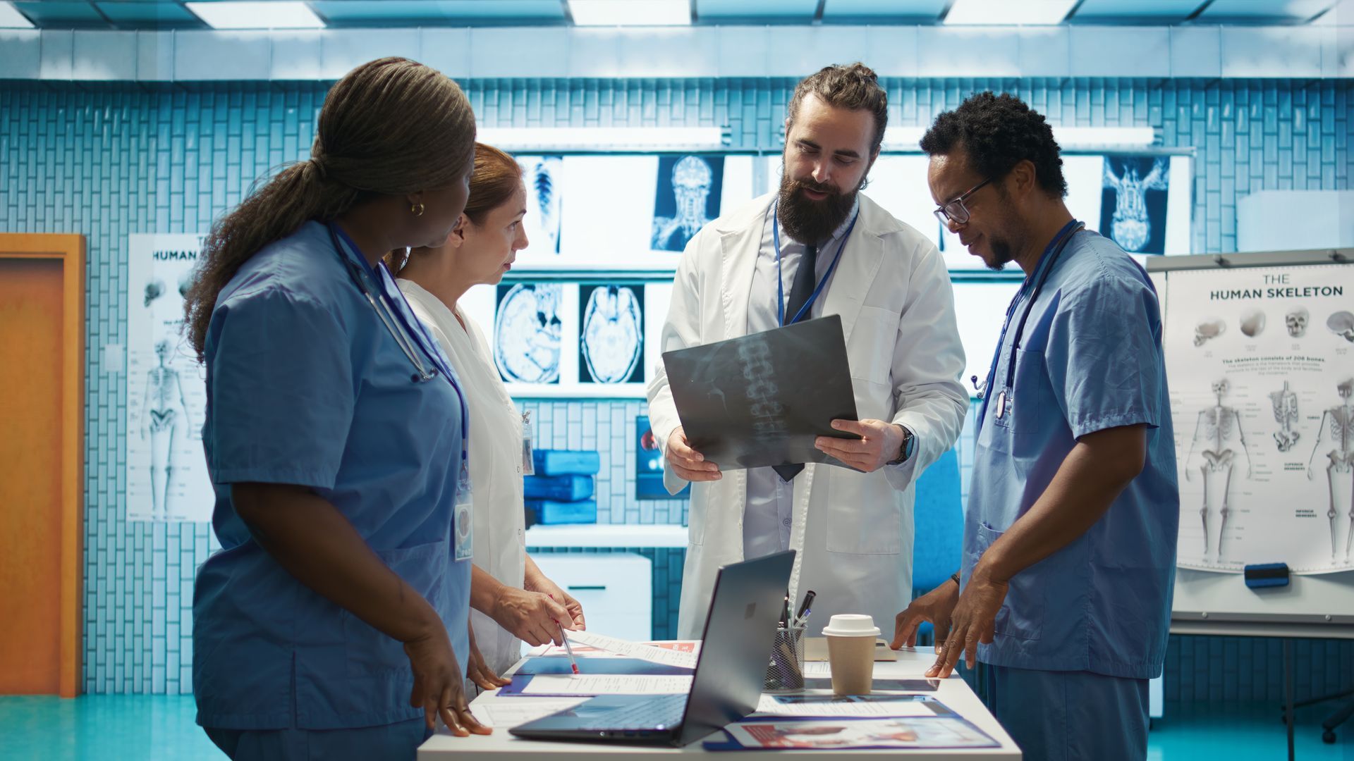 Medical professionals reviewing an X-ray in a hospital room. Medical professionals reviewing an X-ray in a hospital room.
