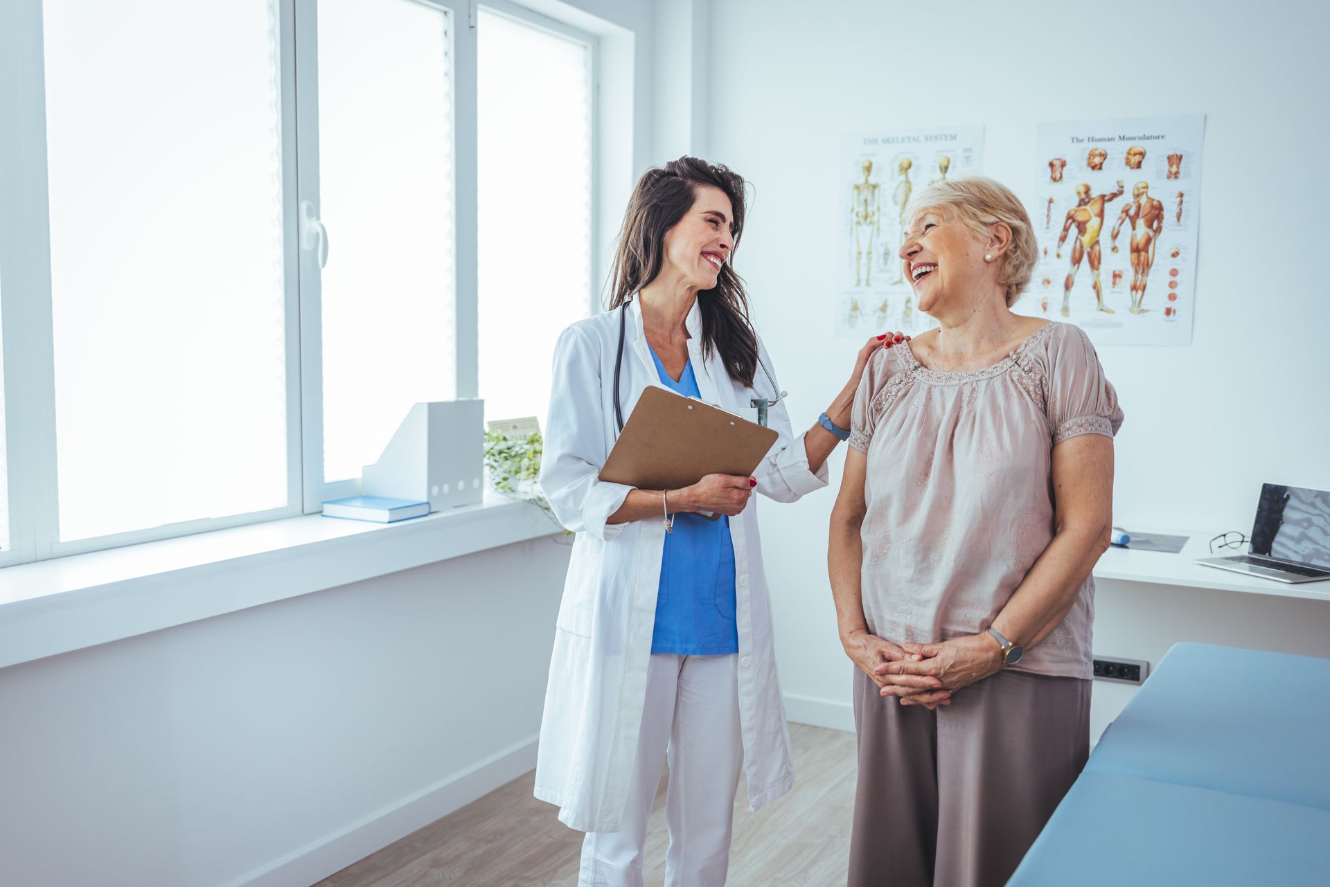 Doctor in white coat with clipboard, talking with patient in exam room. Doctor in white coat with clipboard, talking with patient in exam room.