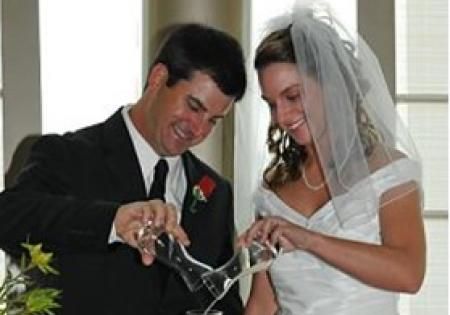 Bride and groom pouring champagne together at their wedding reception