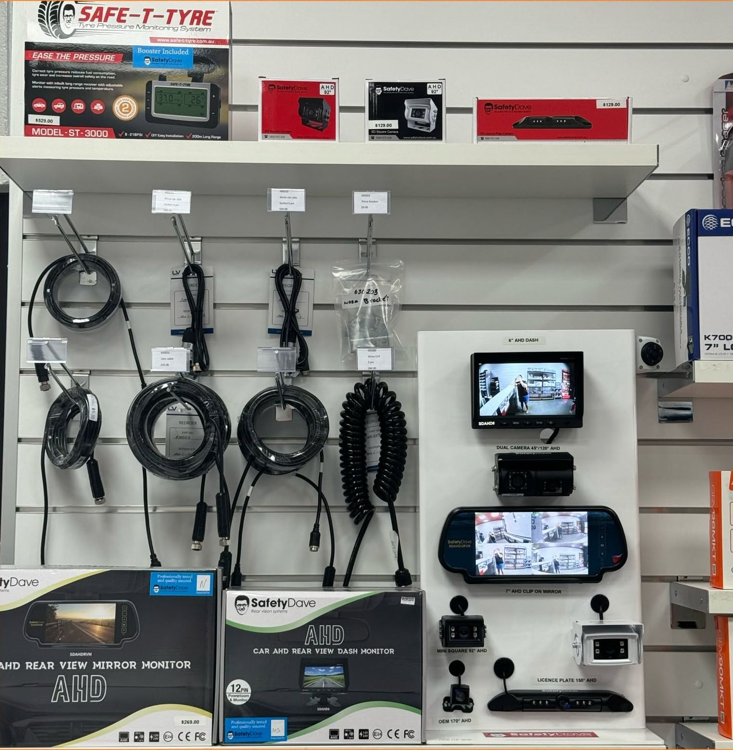 Retail Display Wall With Coiled Cables, Car Audio Accessories, and Two Screens Showing a Camera Feed — Innisfail Auto Electrics Pty Ltd in Mundoo, QLD
