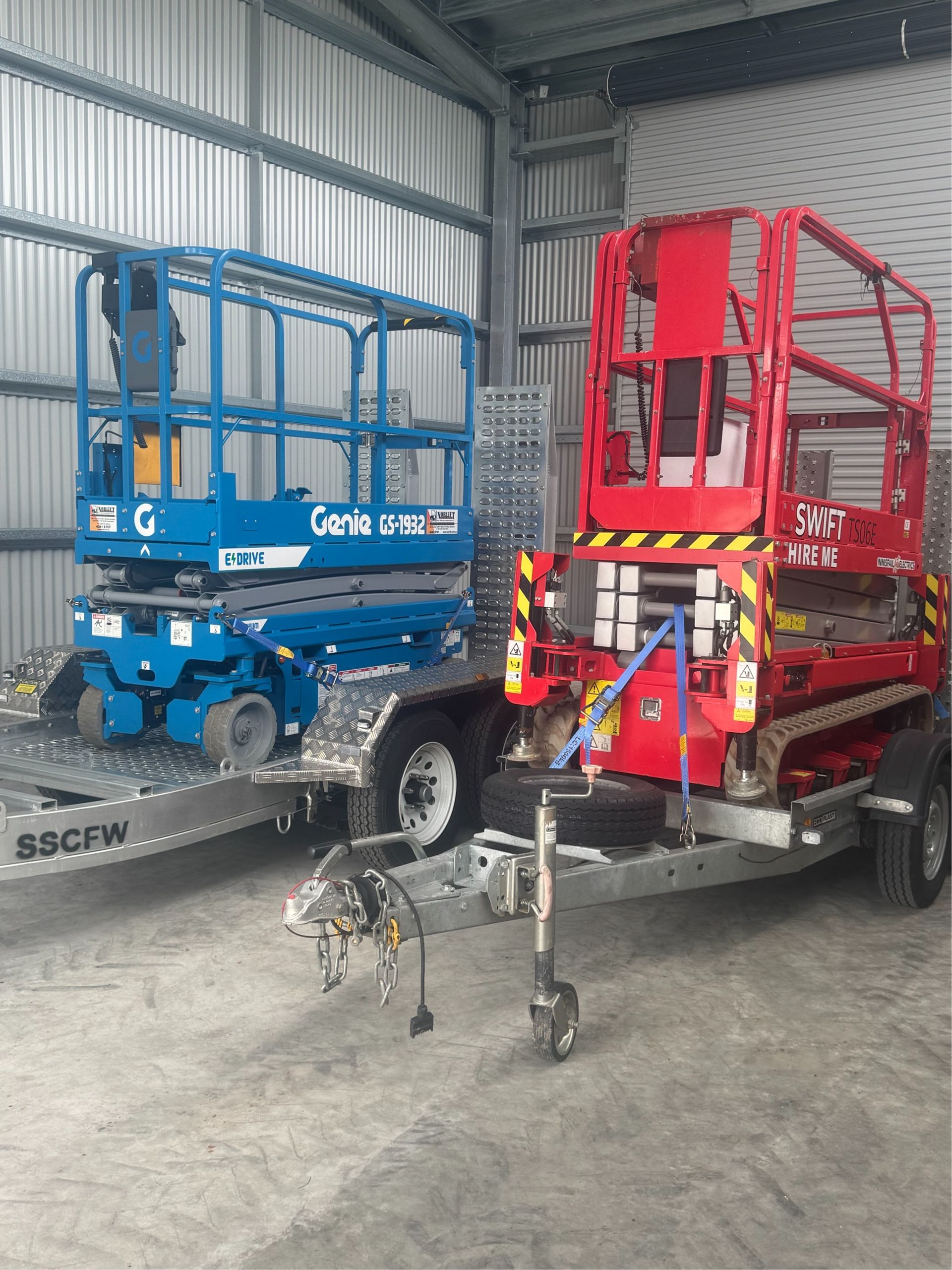 A Red Scissor Lift is Sitting in the Ceiling of a Building — Innisfail Auto Electrics Pty Ltd in Mundoo, QLD