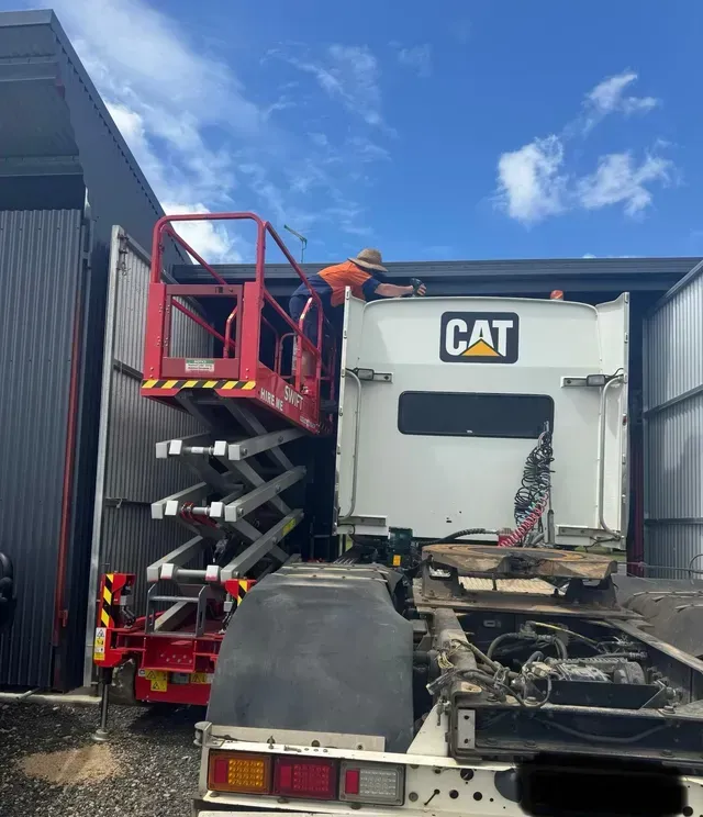 A Technician Fixing Air Conditioning on a Truck — Innisfail Auto Electrics Pty Ltd in Mundoo, QLD