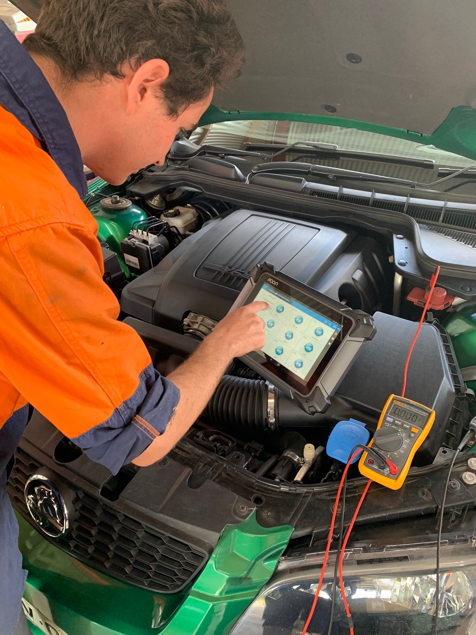 Man Hand Checking Car Battery — Innisfail Auto Electrics Pty Ltd in Mundoo, QLD