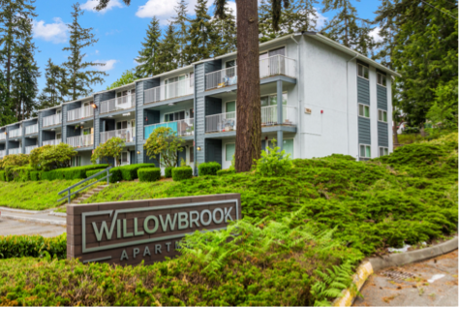 a willowbrook apartment building with a sign in front of it