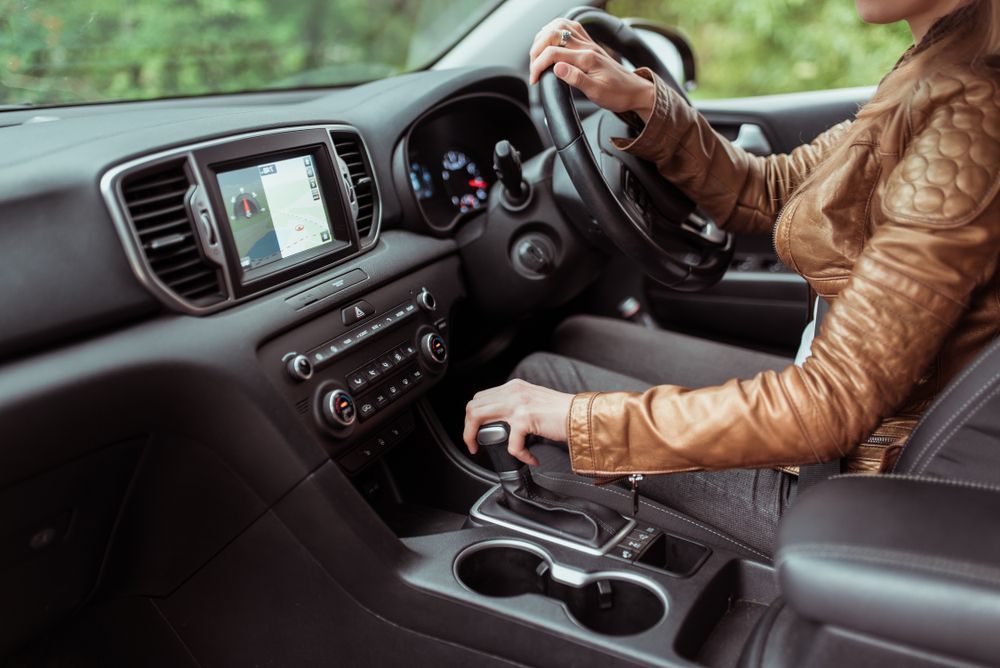 Person Driving a Car, Hand on Steering Wheel and Another on Gear Shift — Auto Maniac in Mossman, QLD