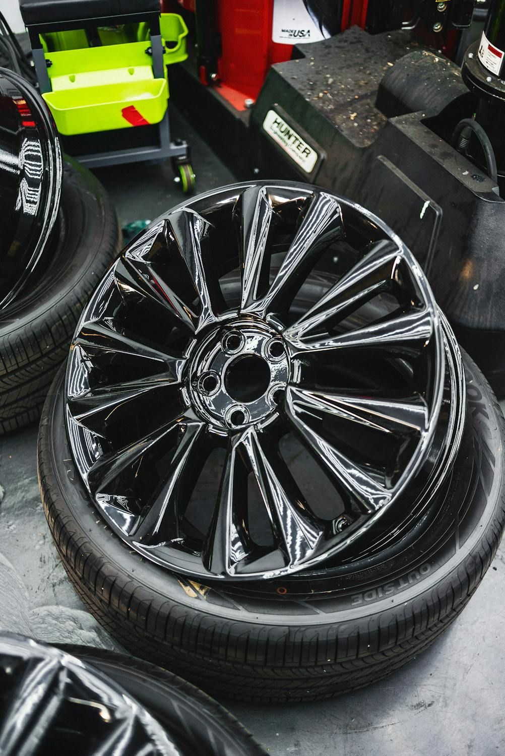 A Stack Of Black Wheels And Tires Are Sitting On A Table — Auto Maniac in Mossman, QLD