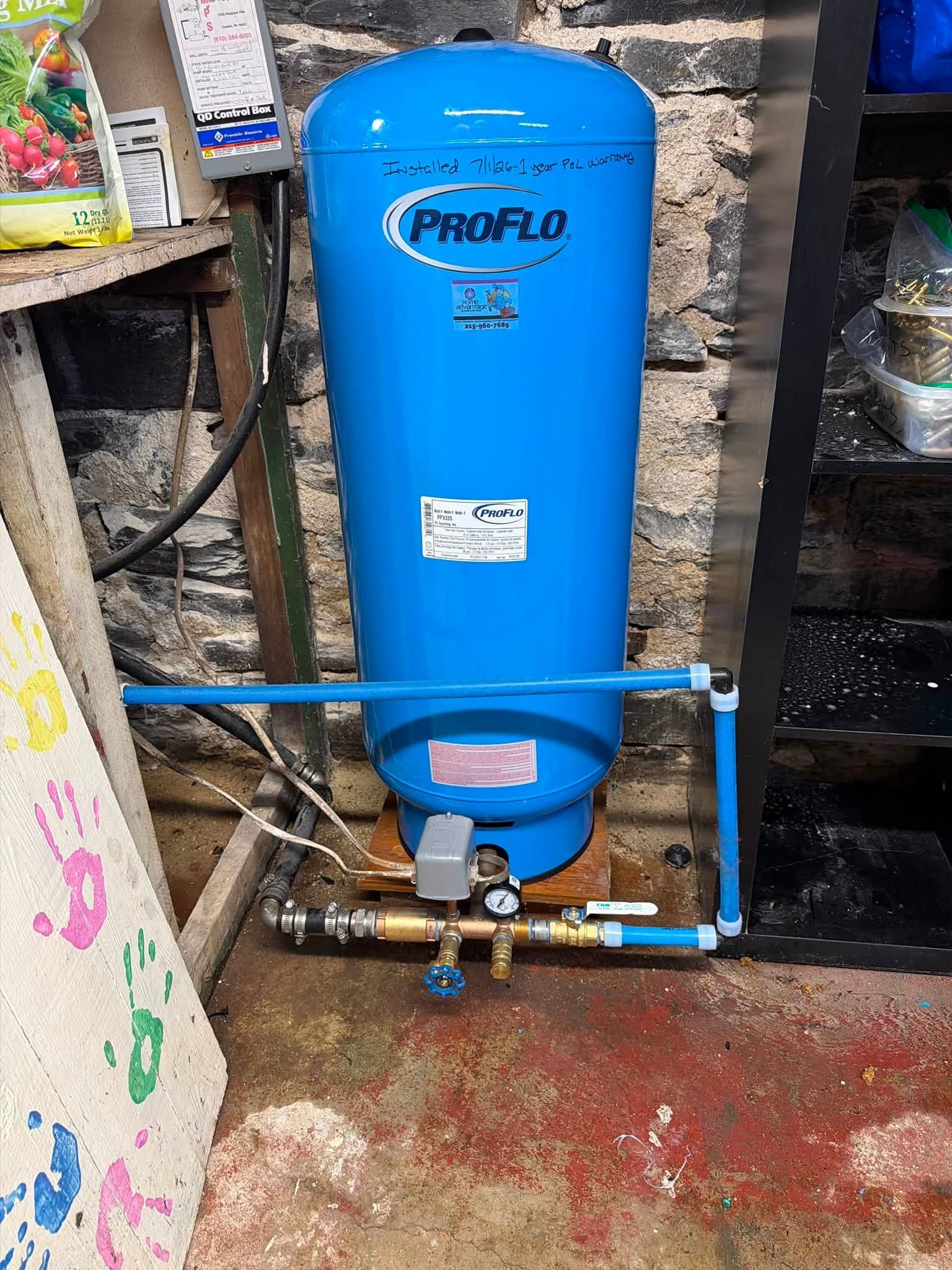 Blue ProFlo water softener tank with plumbing valves and pipes in a utility area.