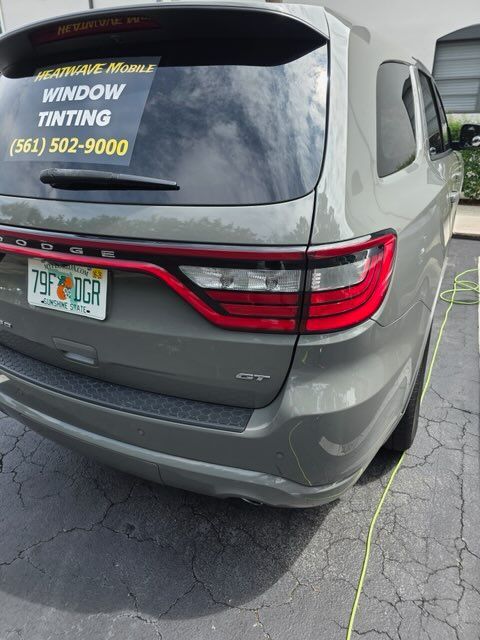 Gray Dodge Durango SUV with window tinting and a Florida license plate.