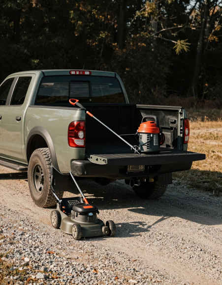 Lawn care work truck with equipment on a gravel driveway