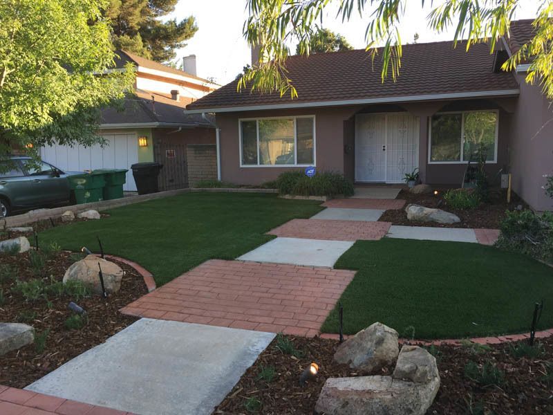 A house with a brick walkway leading to it