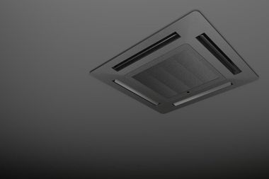 Ceiling-mounted air vent with a gray grille on a light gray ceiling