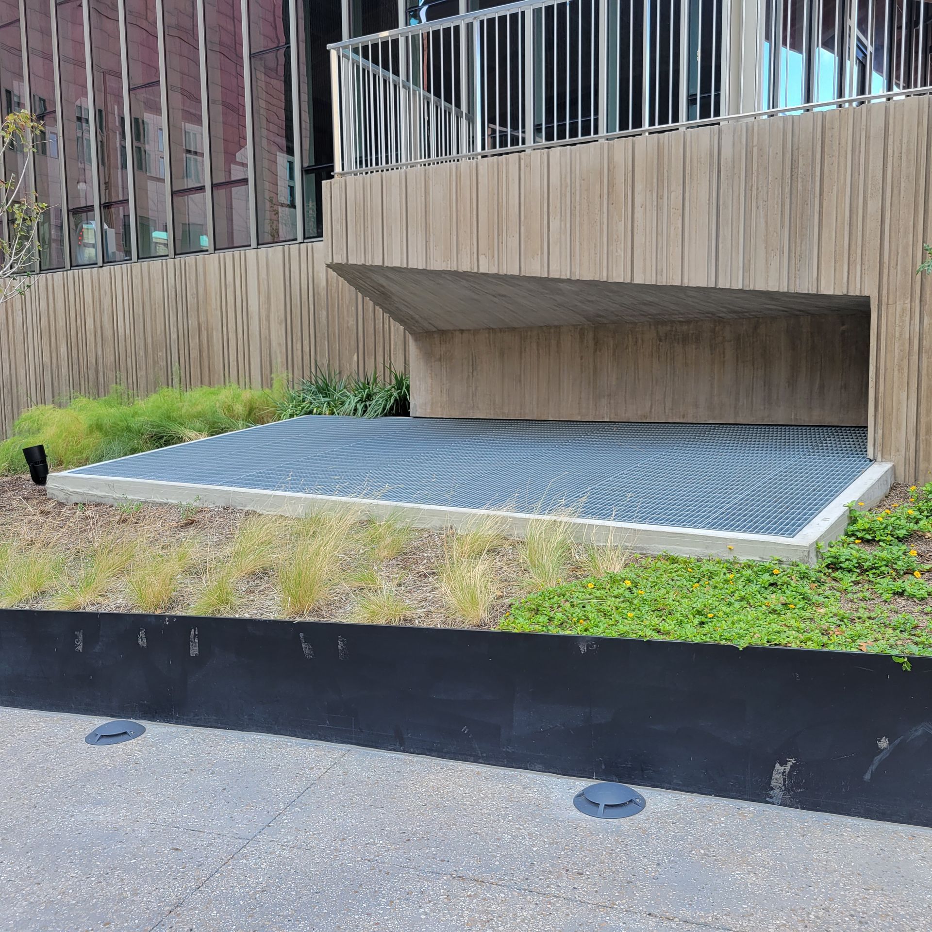 A building with a fence and a concrete floor