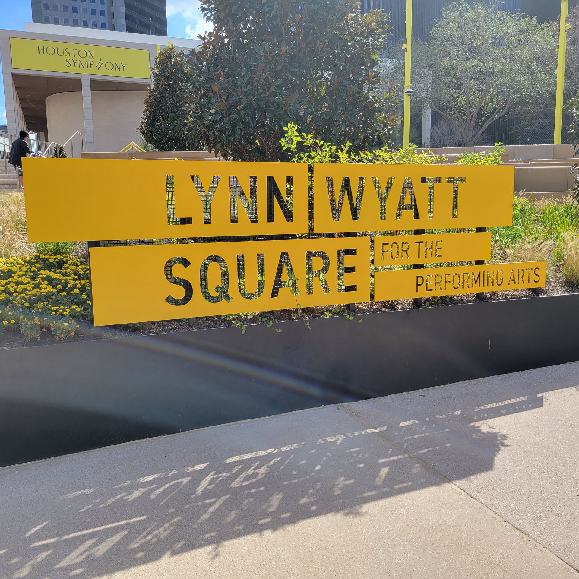 A yellow sign that says lynn wyatt square on it