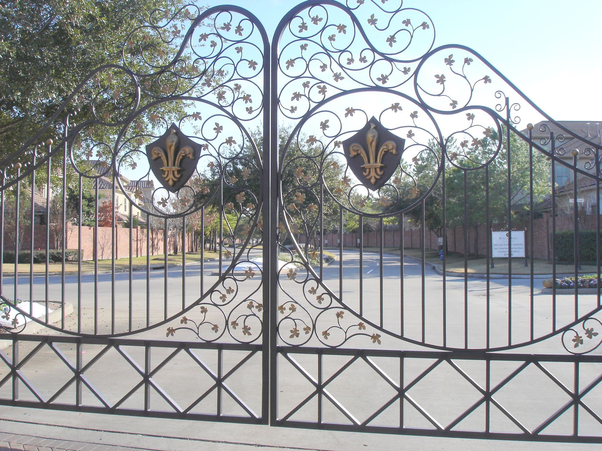 A wrought iron gate with a fleur de lis on it