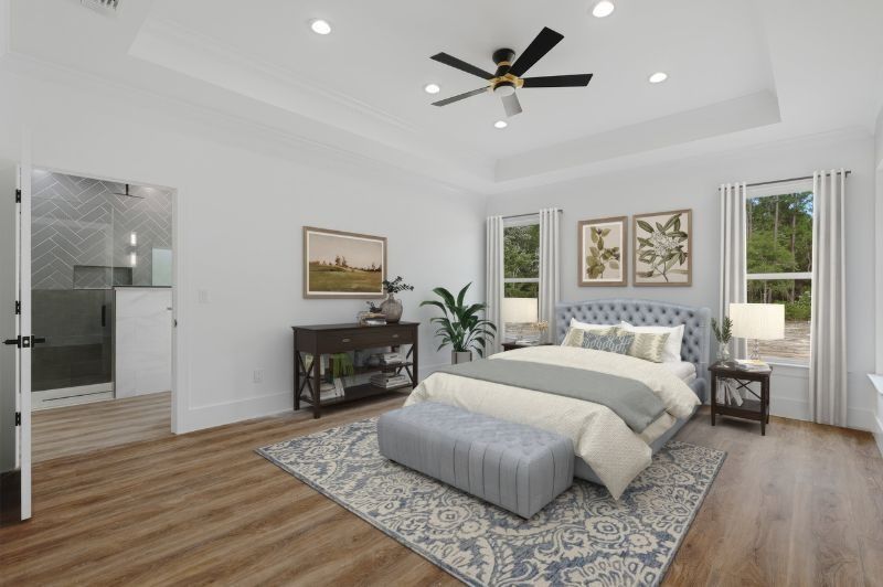 Bedroom with light gray walls, wood floor, and a bed with a tufted headboard.