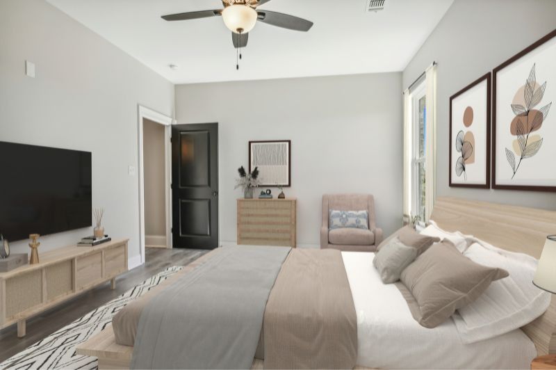Bedroom with a bed, TV, dresser, and artwork; neutral color palette.