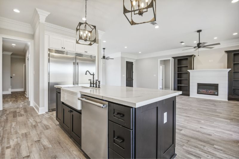 Modern kitchen with a large island and stainless steel appliances.