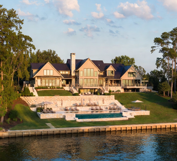 Three craftsman-style luxury lakefront homes on Lake Norman, illuminated by the golden light of sunset.