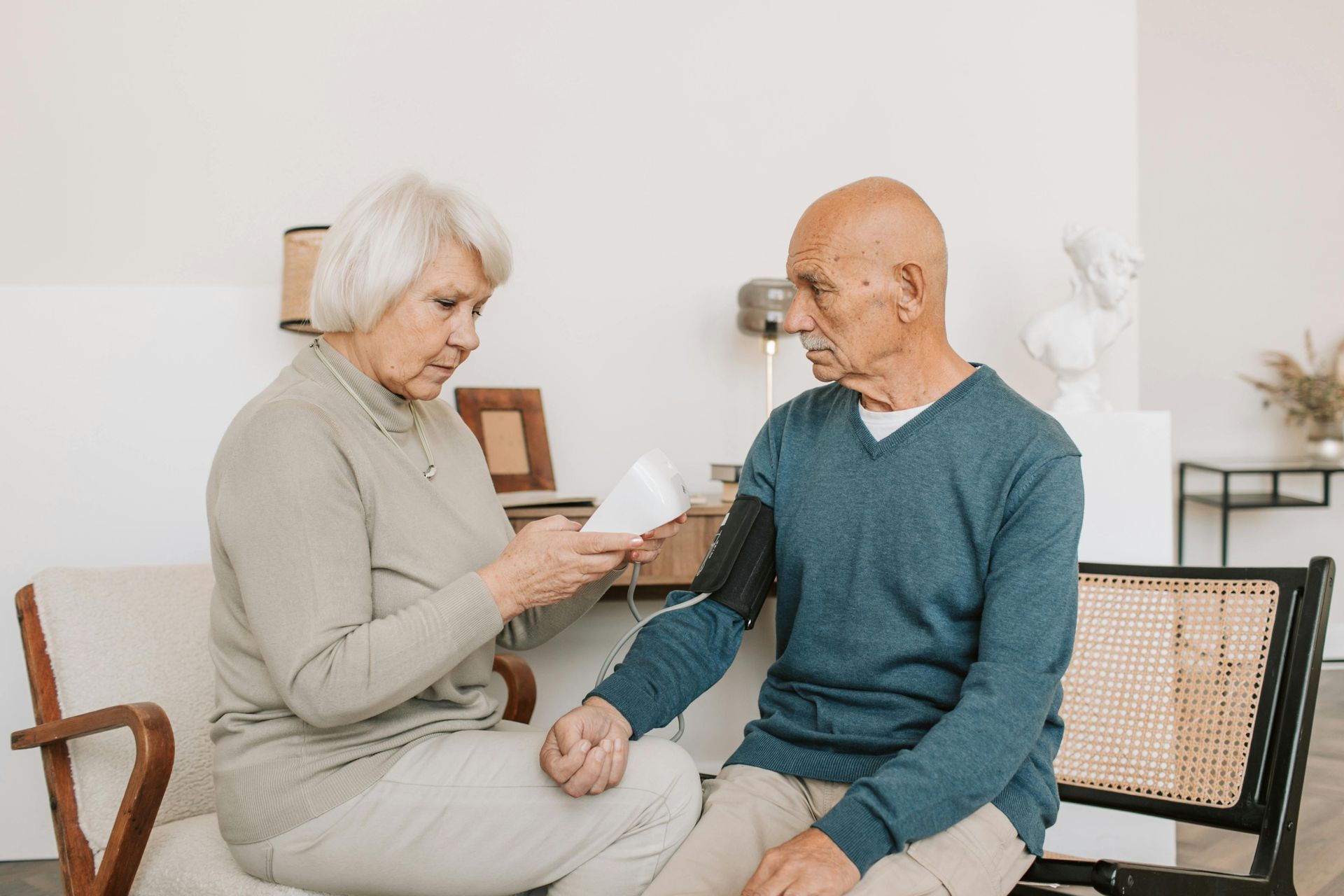 A caregiver helping an elderly man