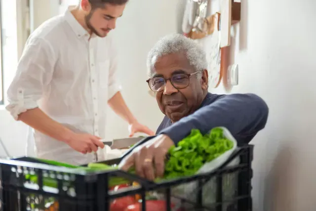Caregiver assisting an older adult with daily activities as part of in-home respite care in Stafford, TX