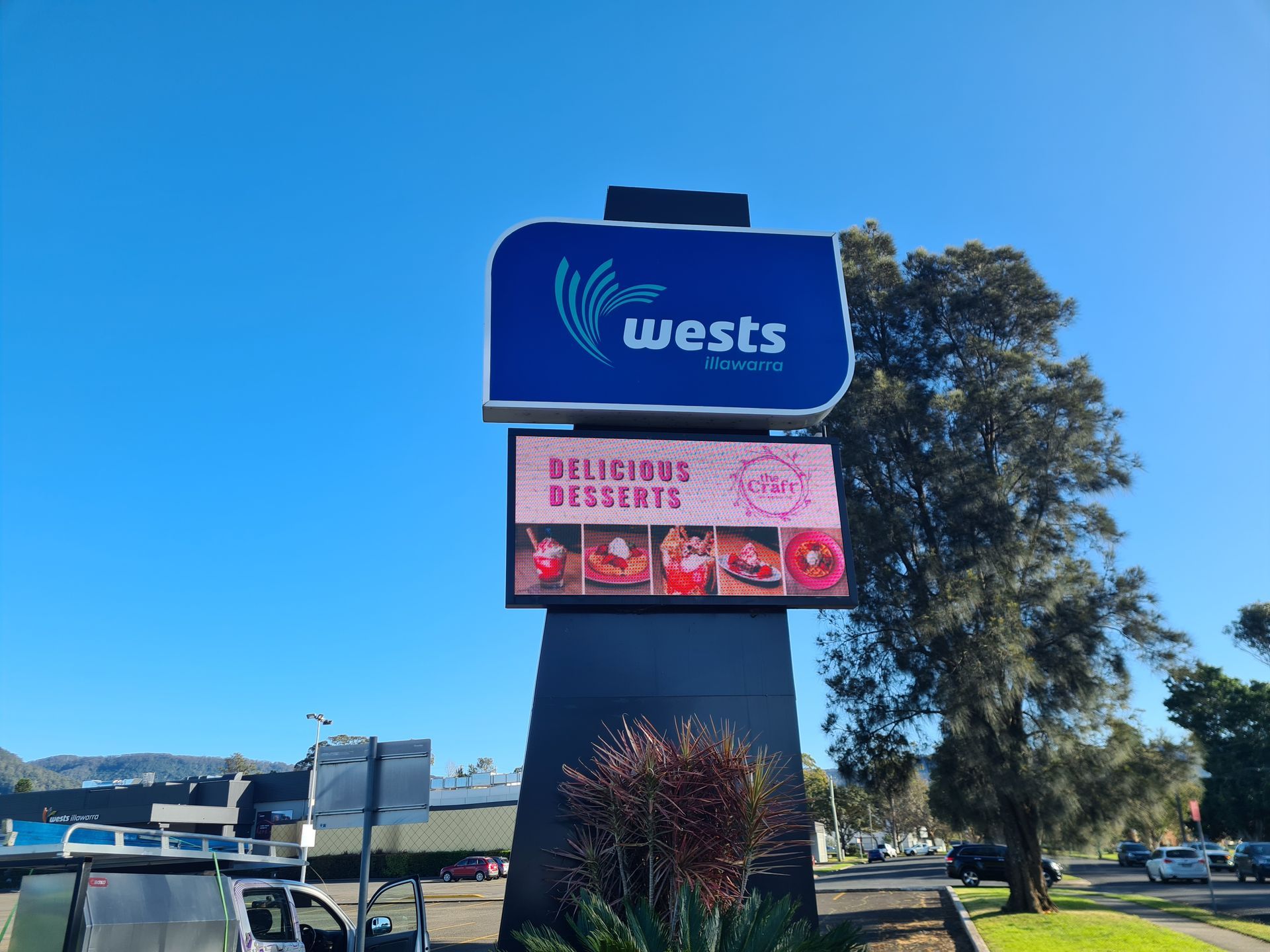 A large blue sign that says wests on it-Professional Signwriter in the Illawarra