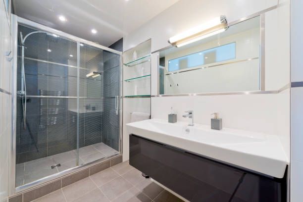 A bathroom with a sink and a walk in shower.