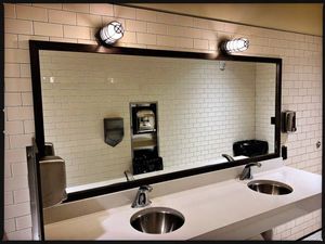 A bathroom with two sinks and a large mirror