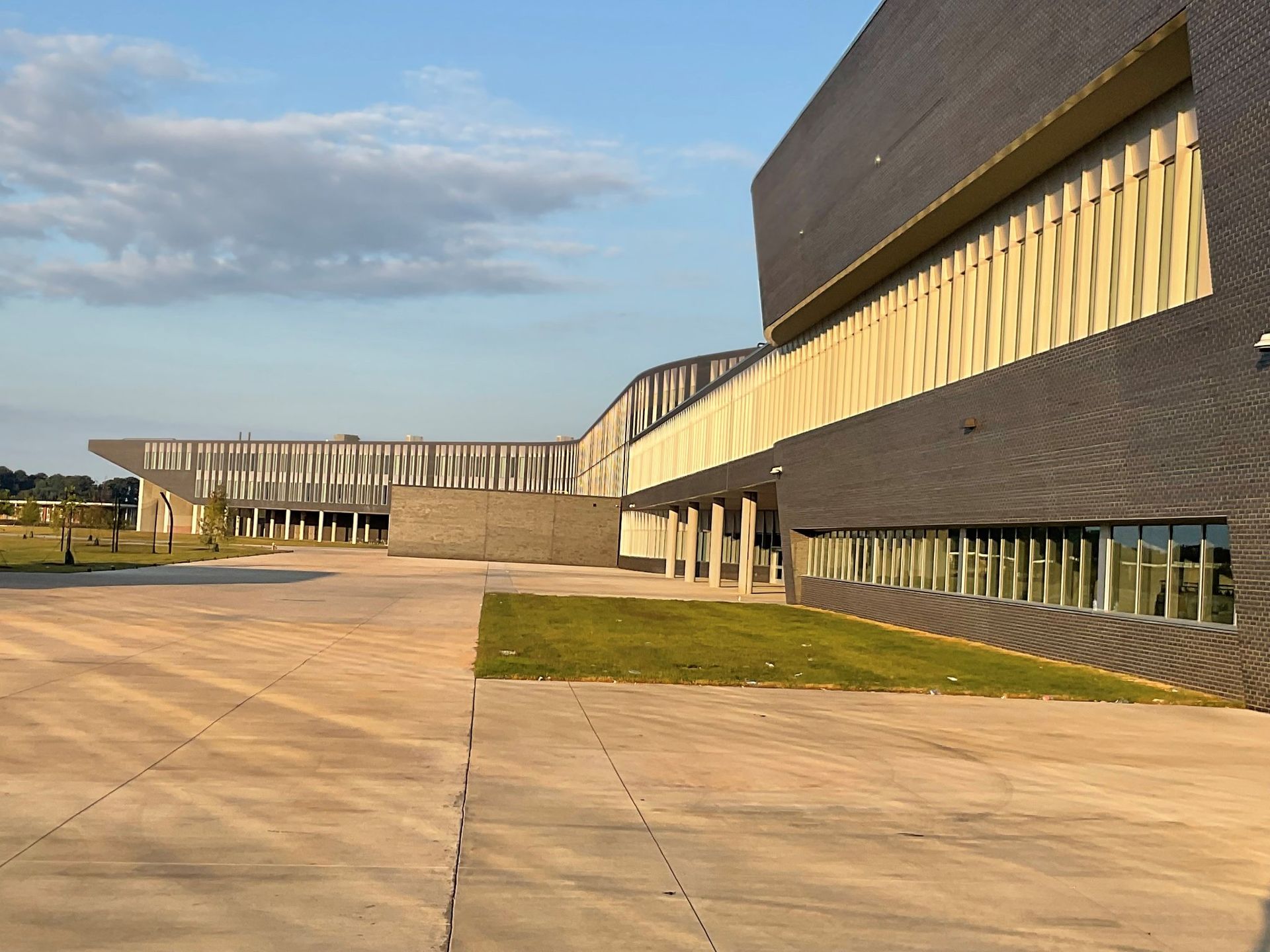 A large building with a lot of windows and a walkway leading to it