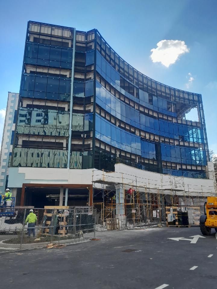 A large building with a lot of windows is under construction.