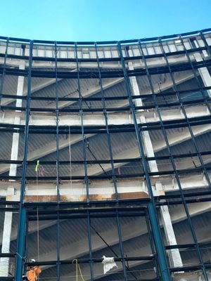 A large building under construction with a blue sky in the background