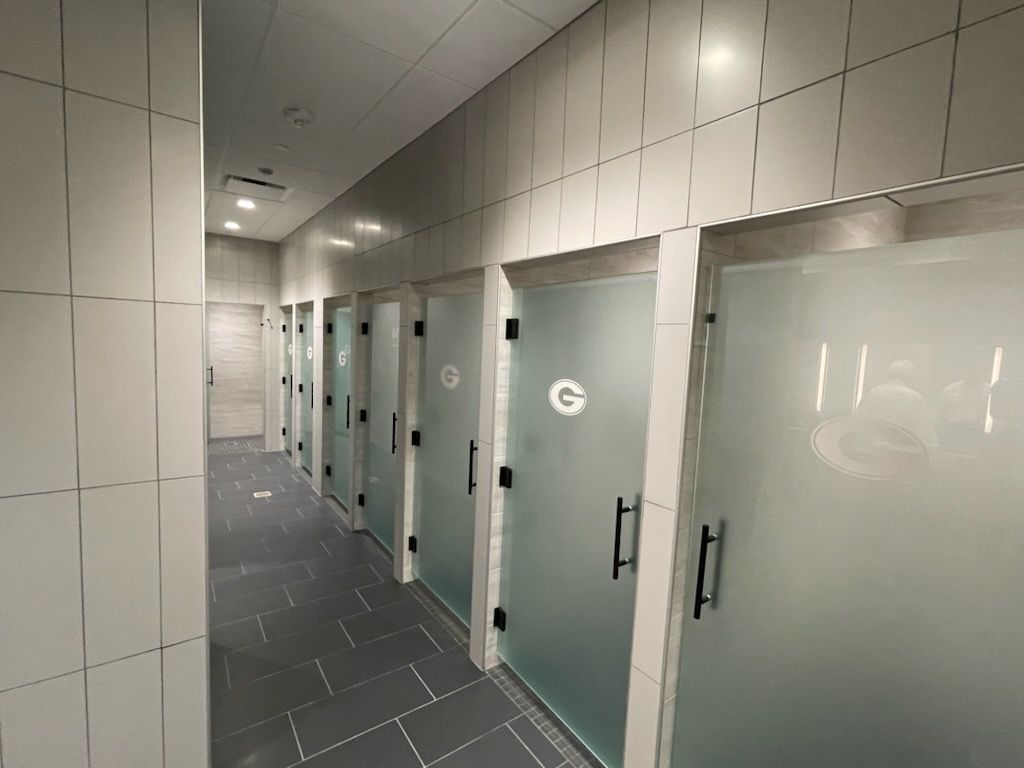 A hallway with a row of frosted glass doors