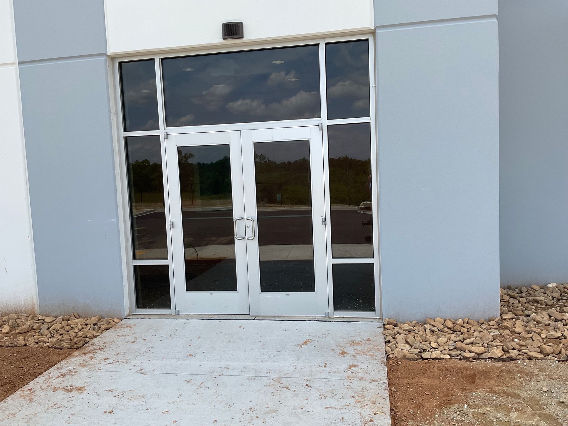 A building with a concrete walkway leading to the door