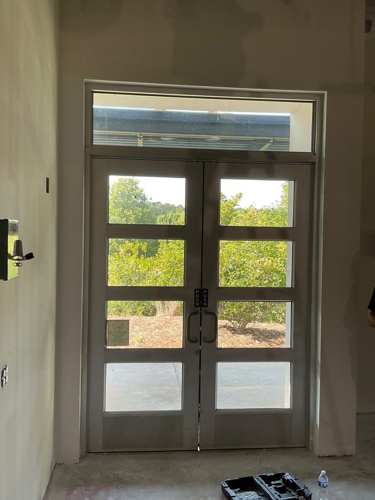 Glass entrance door with sidelights and aluminum framing at Lanier Technical College in Griffin, GA.