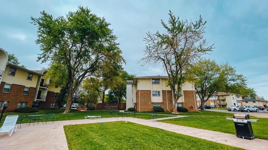 a row of buildings with trees in front of them in a residential area .