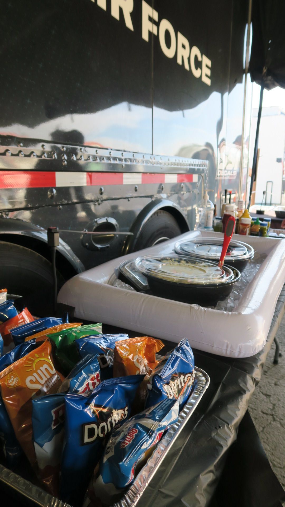 A tray of doritos chips sits on a table in front of a sign that says air force