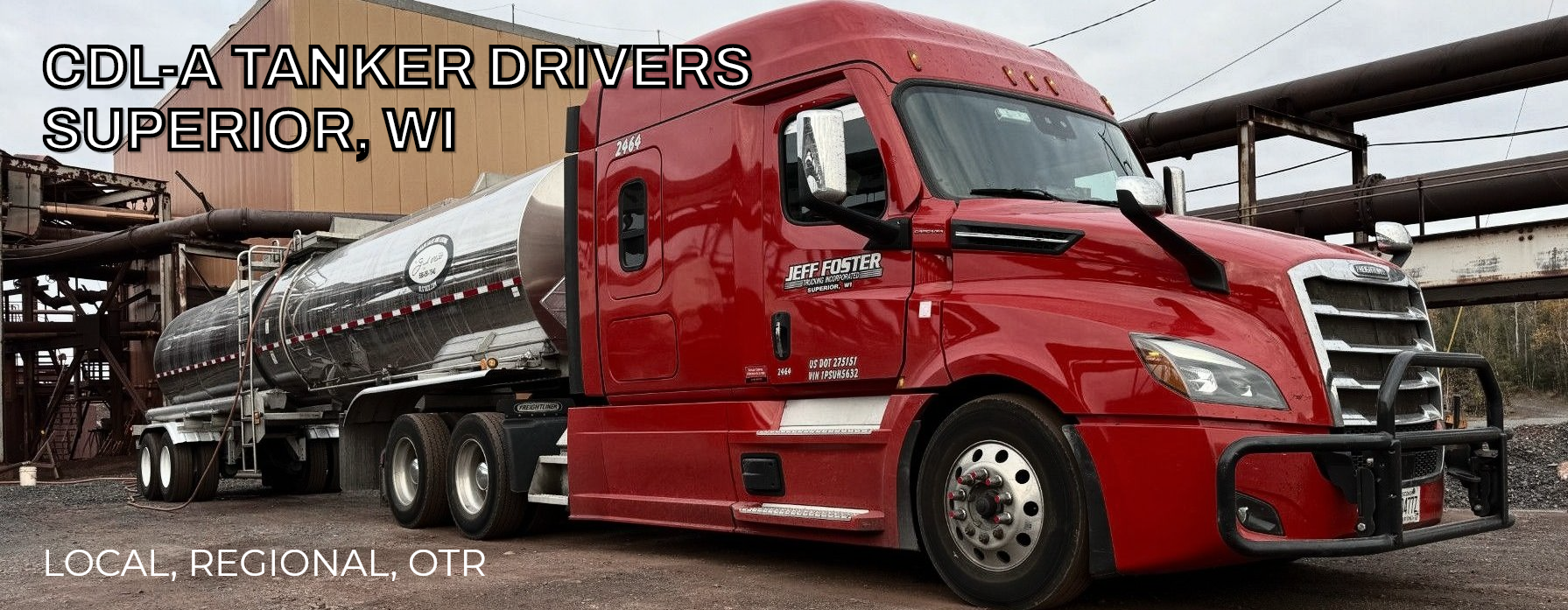 A red semi-truck with a tanker trailer parked in an industrial setting.