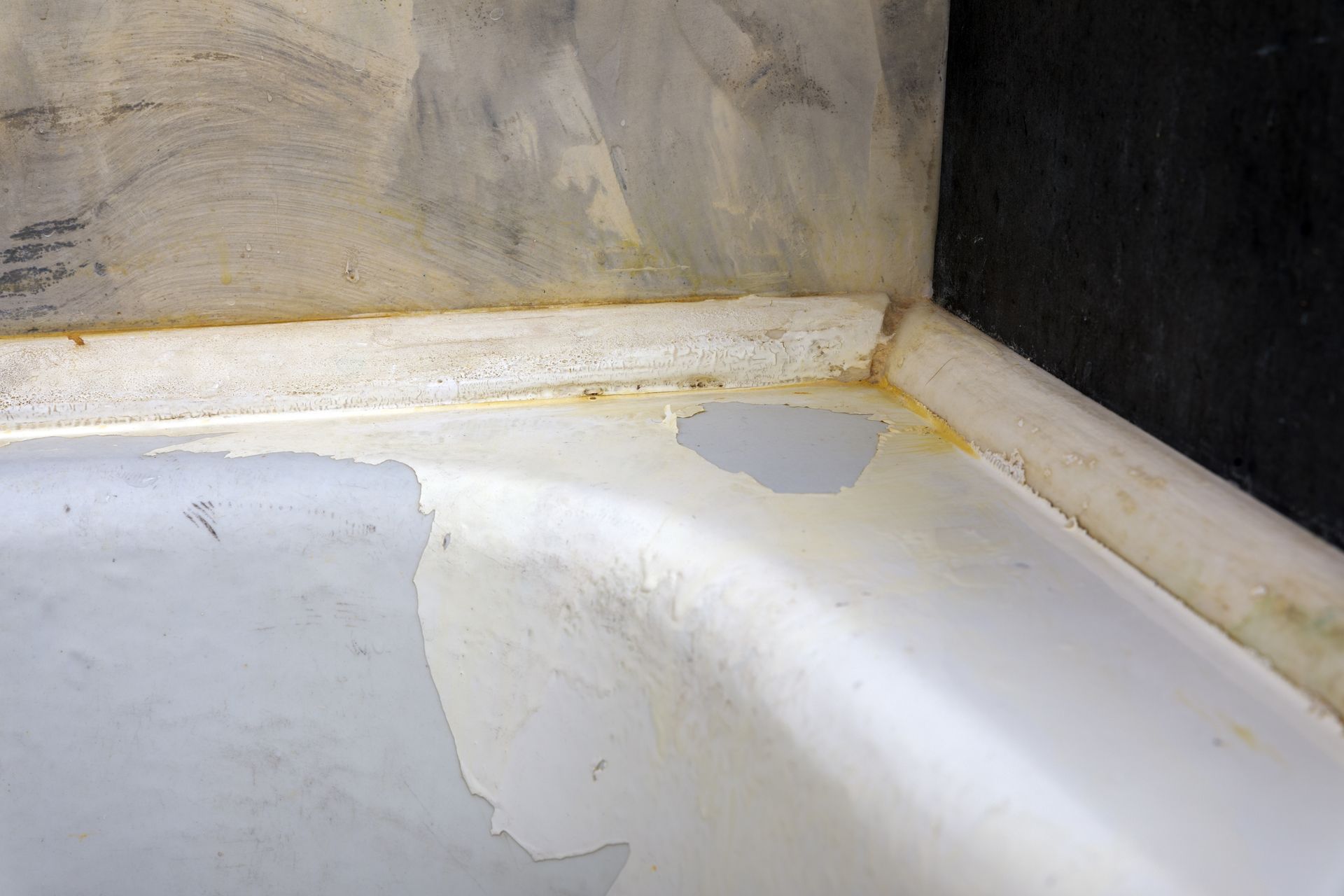 Peeling bathtub paint close-up. Peeling bathtub paint close-up.