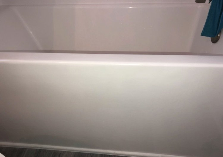 White bathtub with shower curtain in a bathroom