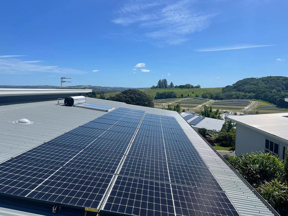 A Row of Solar Panels on the Roof of a Building — Ocean Air Electrical in Evans Head, NSW