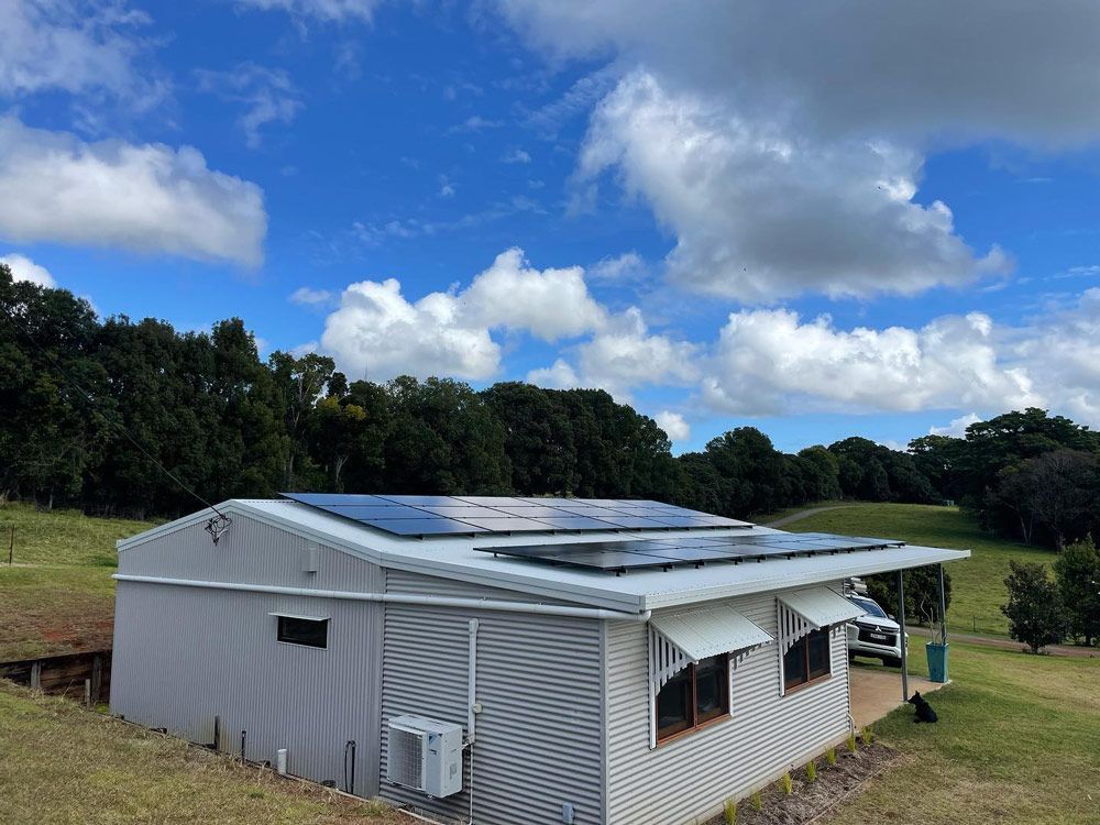 A White House With Solar Panels on the Roof — Ocean Air Electrical in Evans Head, NSW