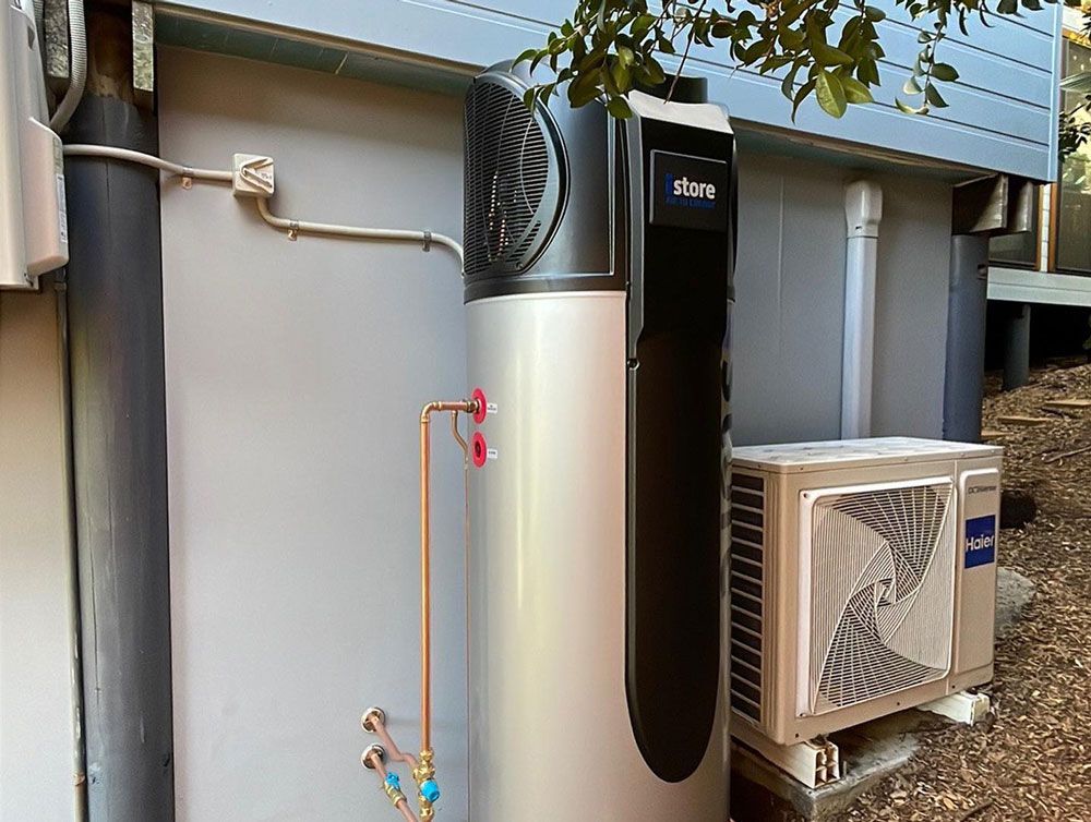 A Water Heater is Sitting on the Side of a Building — Ocean Air Electrical in Skennars Head, NSW