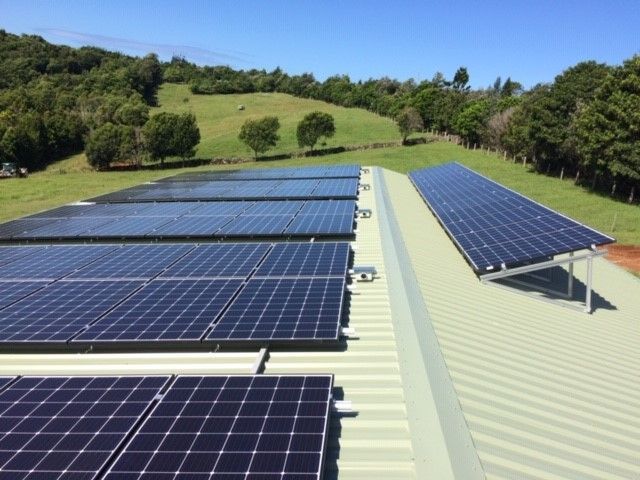 A Row of Solar Panels Installed on the Roof of a Commercial Building — Ocean Air Electrical in Lismore, NSW